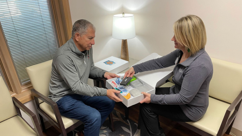 Man being shown what is in brave box